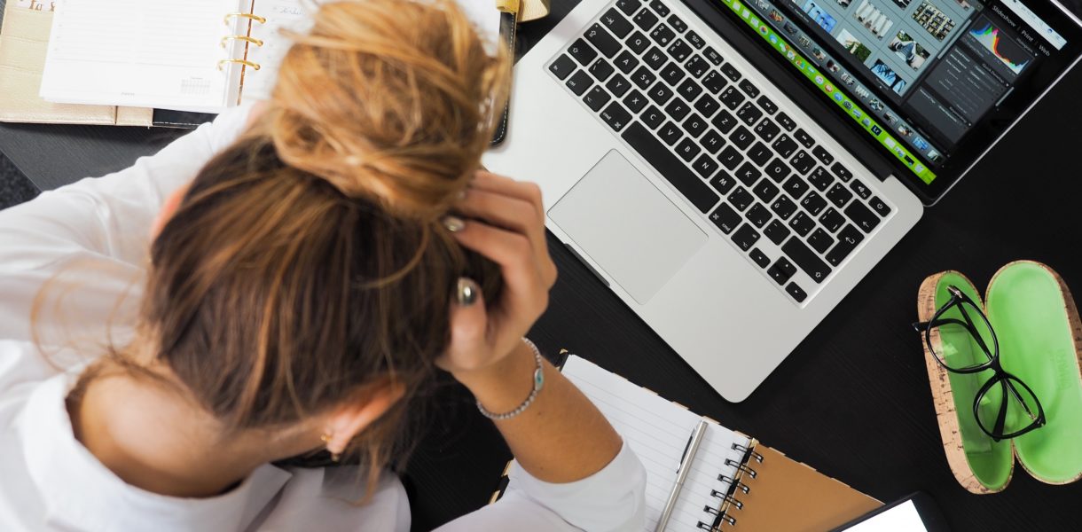 woman using computer and taking notes