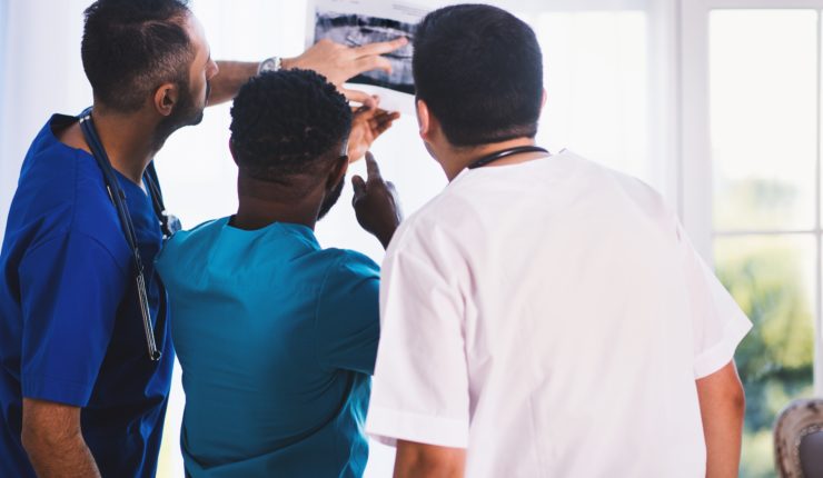 Doctors examining X-ray image