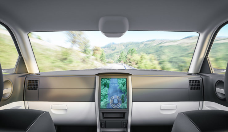 Interior of an autonomous self-driving car on the road.