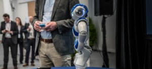 man showcasing small robot
