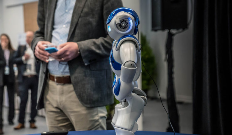 man showcasing small robot