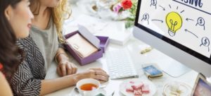 two women working on computer