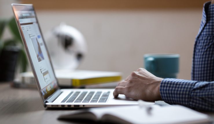 Man sitting at test and typing on computer