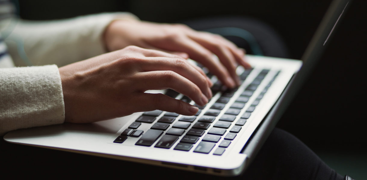 female hands typing com keyboard