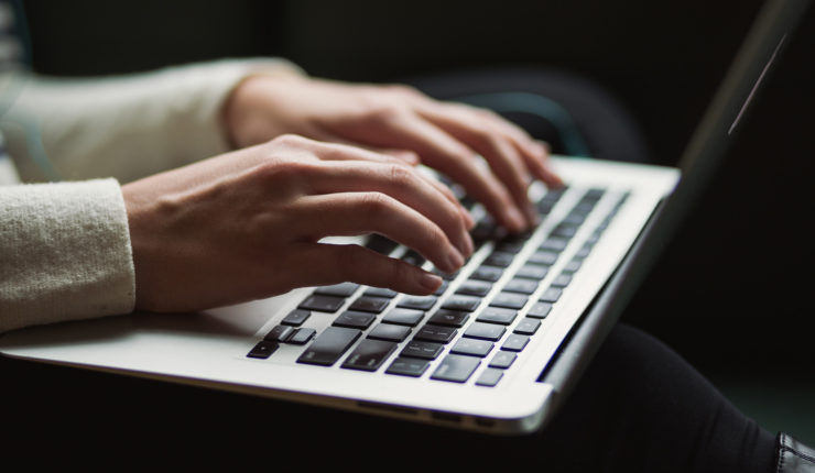 female hands typing com keyboard