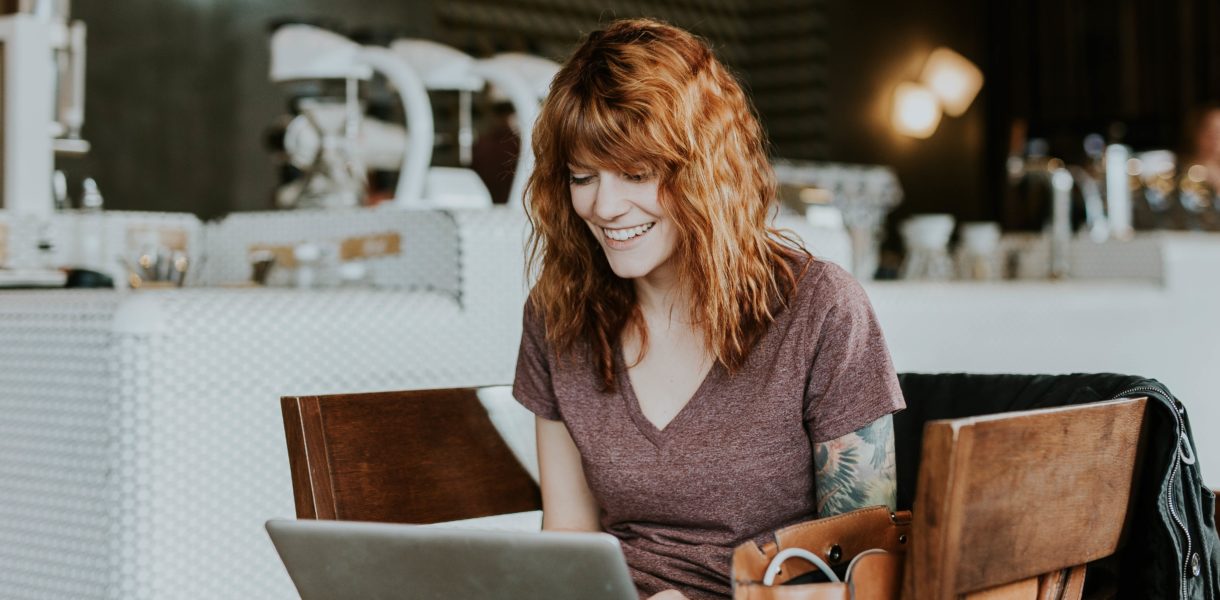 woman sitting on chair working on computer