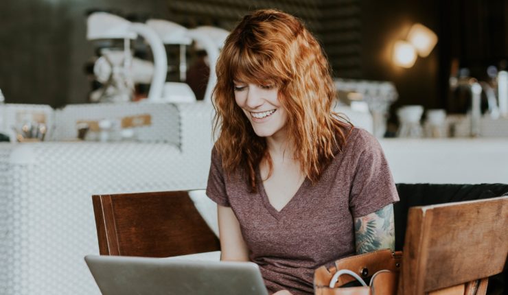 woman sitting on chair working on computer