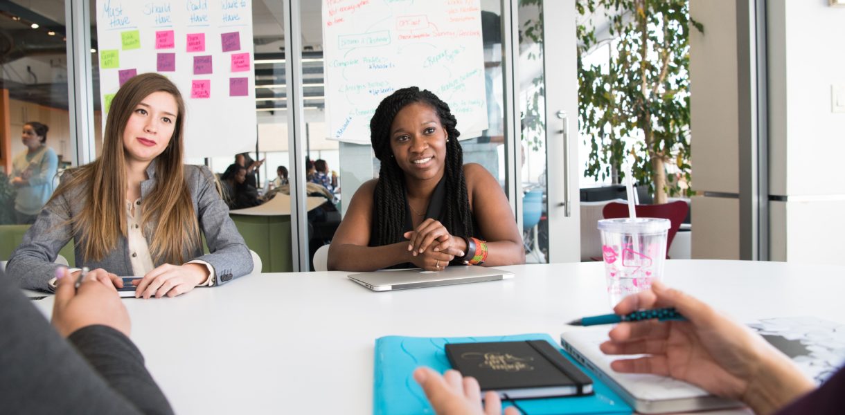 two females in a meeting being interviewed