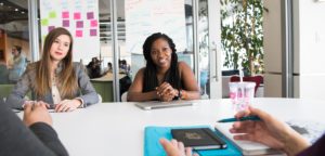 two females in a meeting being interviewed