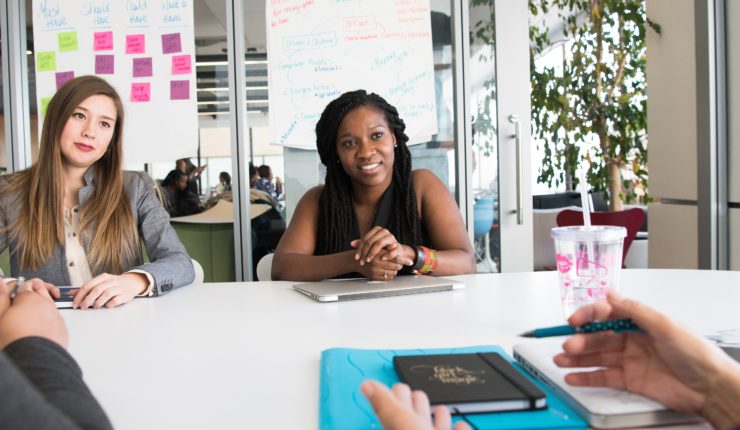 two females in a meeting being interviewed
