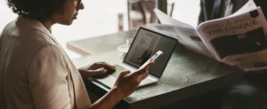 woman using laptop and phone