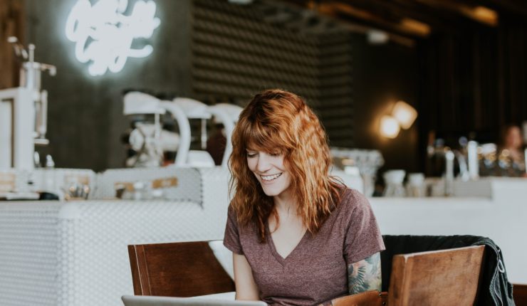 Woman smiling at laptop