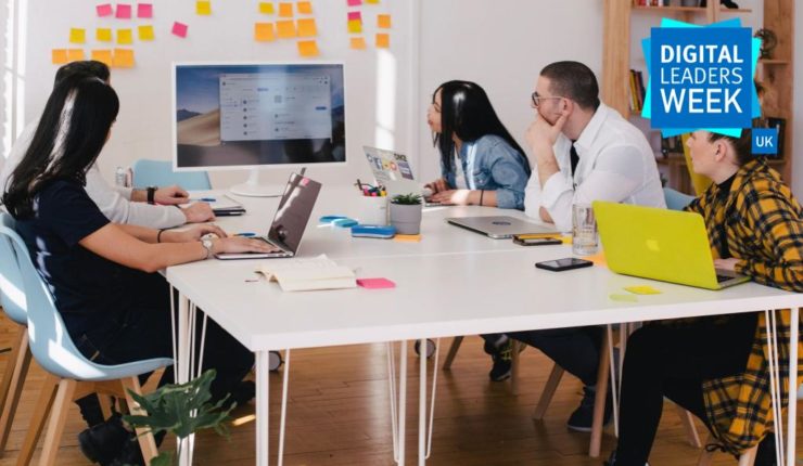 people around table on laptops