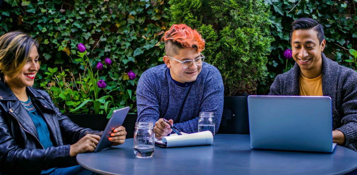 people working on computer outside