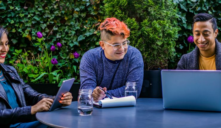 people working on computer outside