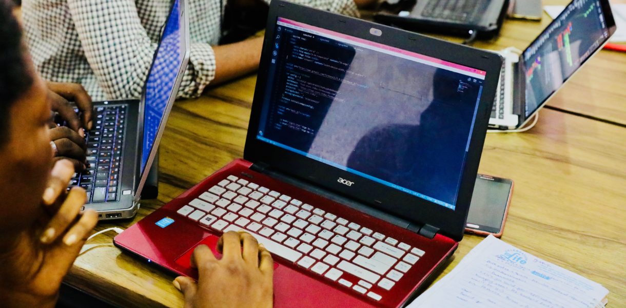 males coding on laptops