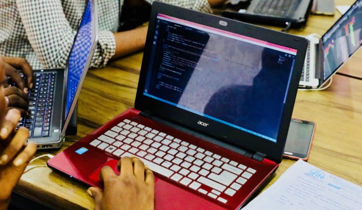 males coding on laptops