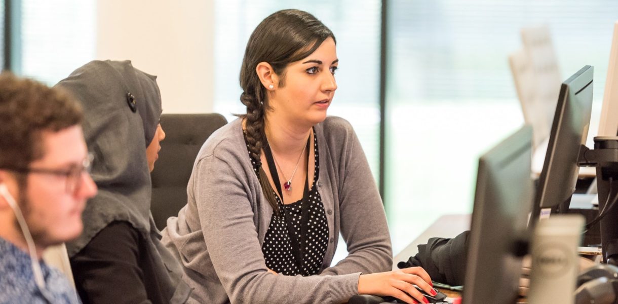 diverse people working on computer in an office