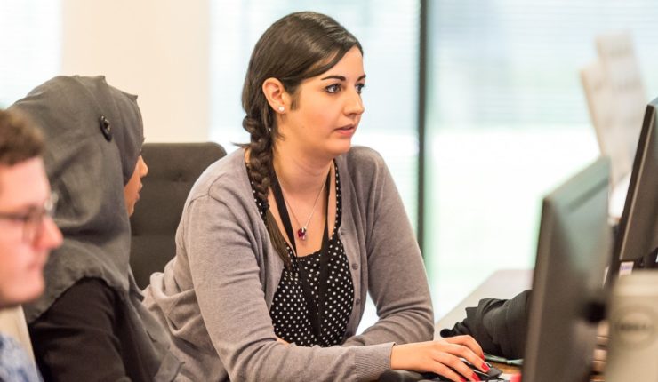diverse people working on computer in an office