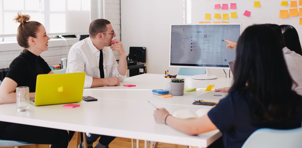 people sitting at a desk working/discussing