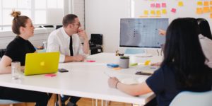 people sitting at a desk working/discussing