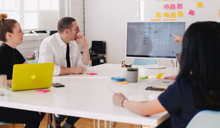people sitting at a desk working/discussing