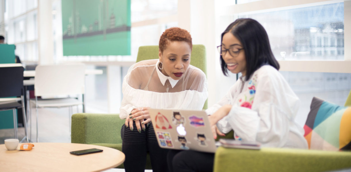 two women looking at computer