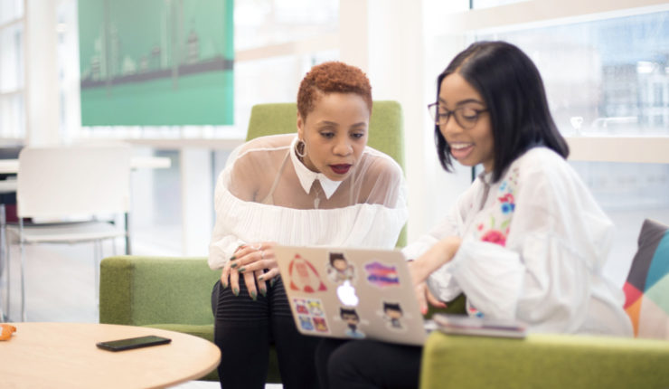 two women looking at computer