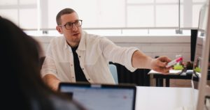 man explaining while sitting at table