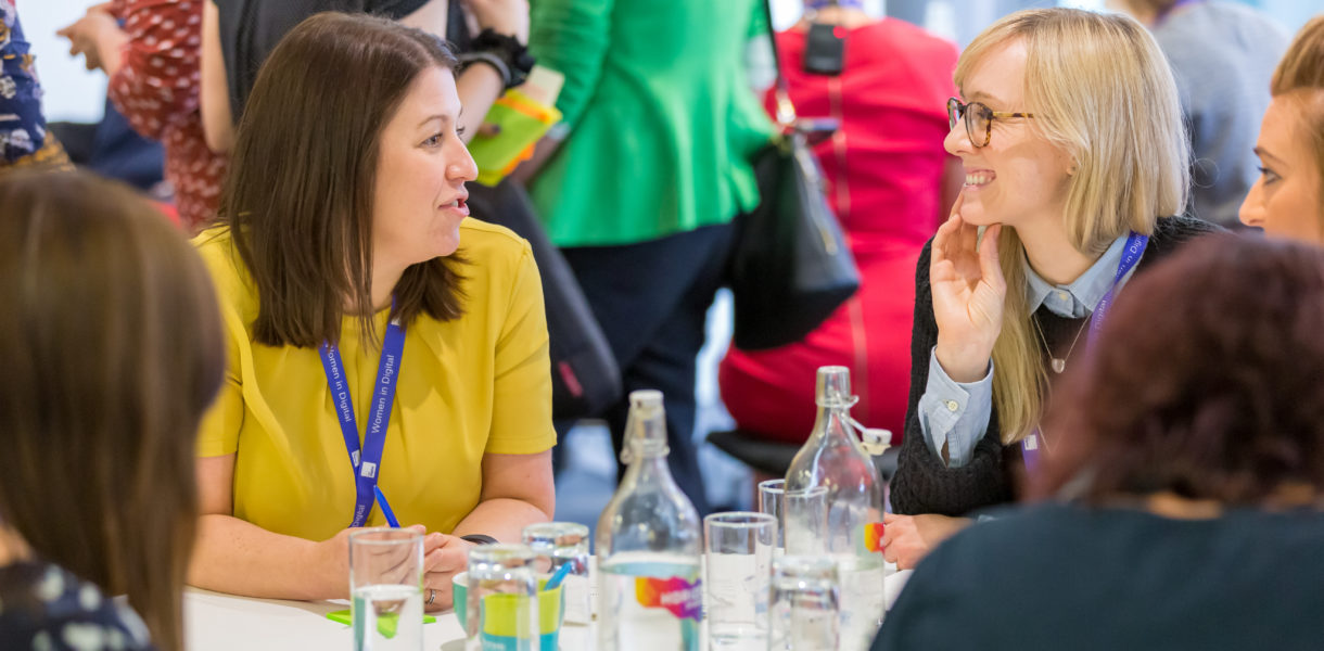 group of women sitting at table talking during DWP event