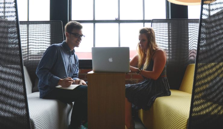 man and woman working on computer