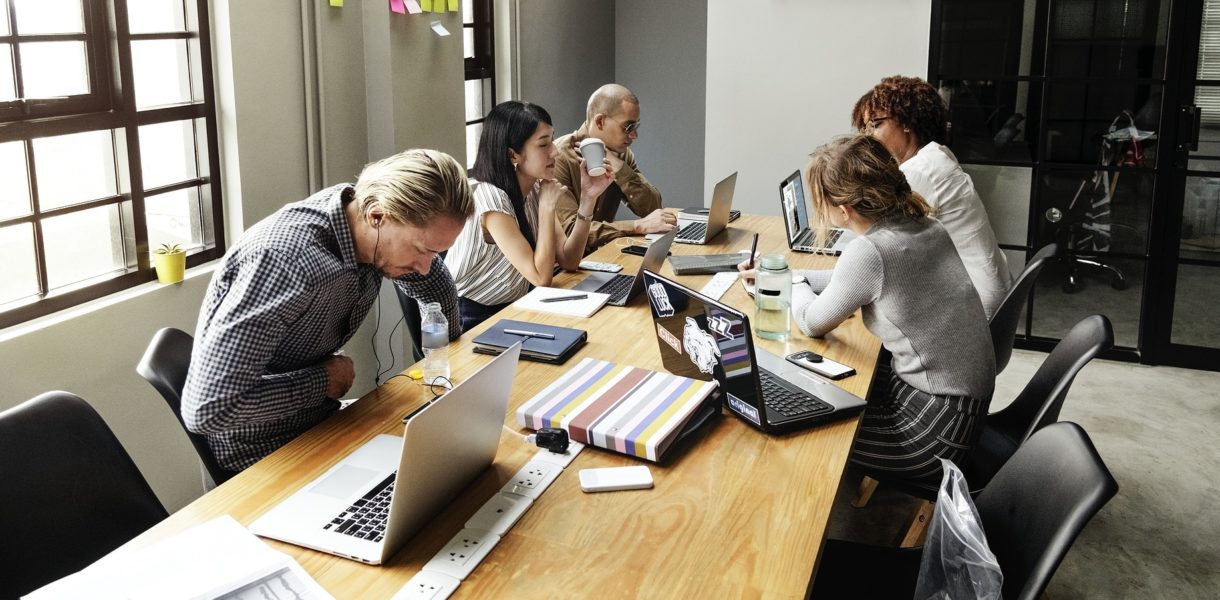 group of people sitting at desk working