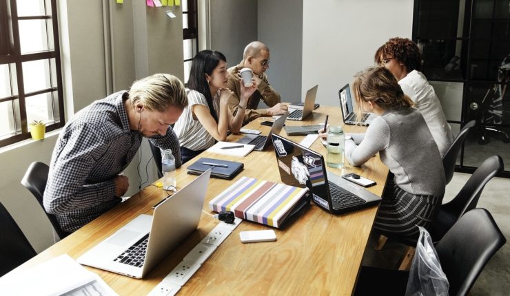 group of people sitting at desk working