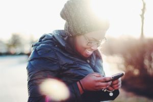 woman typing on phone