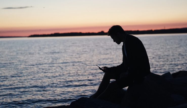 man sitting alone with phone