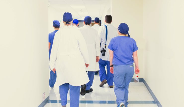 doctors and nurses walking down hallway