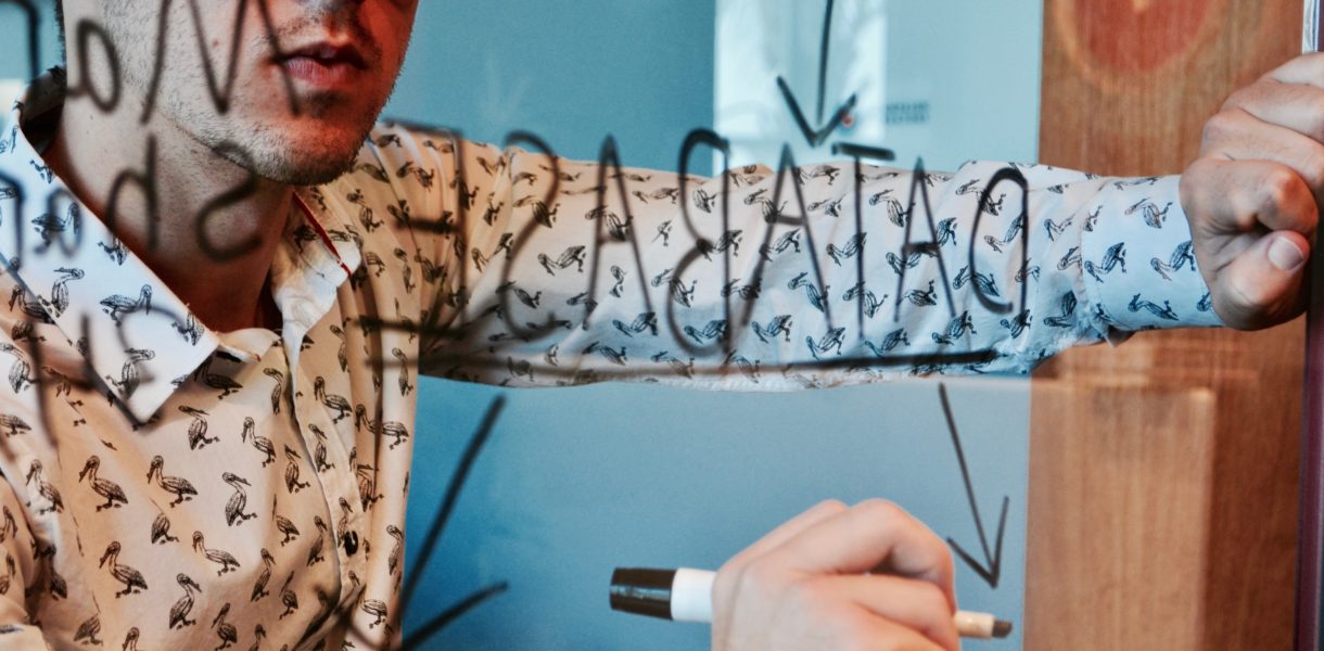 man writing on mirror