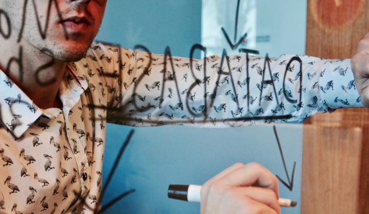 man writing on mirror