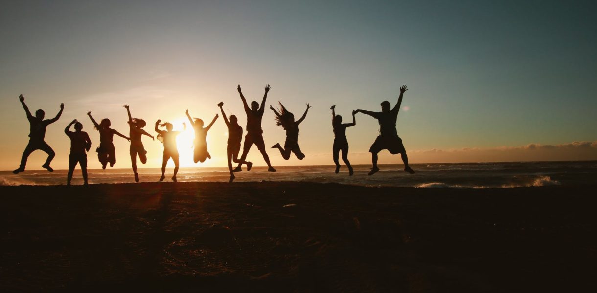 people jumping with the sunset in the background
