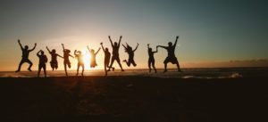 people jumping with the sunset in the background