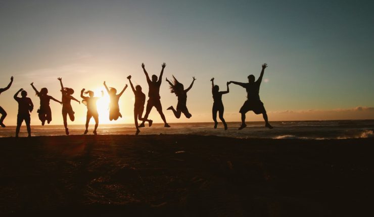 people jumping with the sunset in the background
