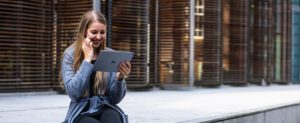woman using ipad and speaking on phone