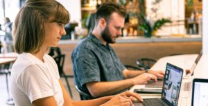 Man and women typing on computer