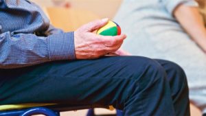 elderly man holding ball