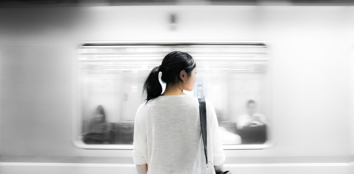 woman standing by train