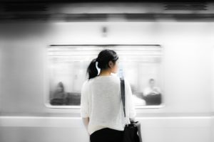 woman standing by train