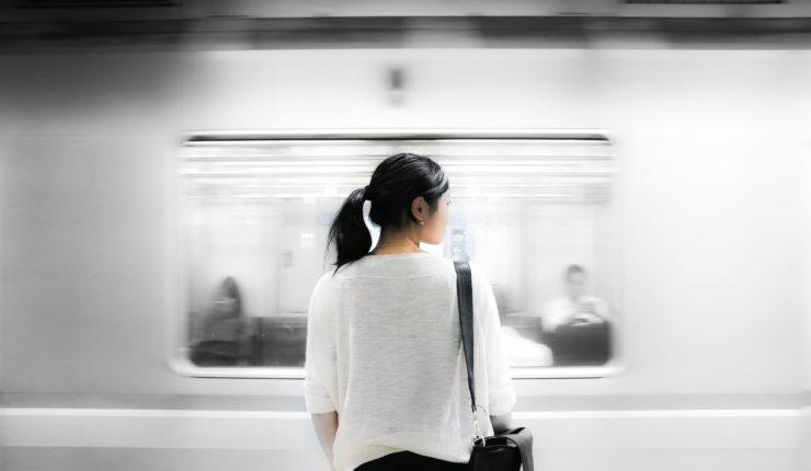 woman standing by train