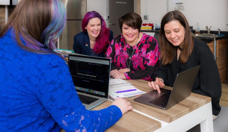women around a meeting table