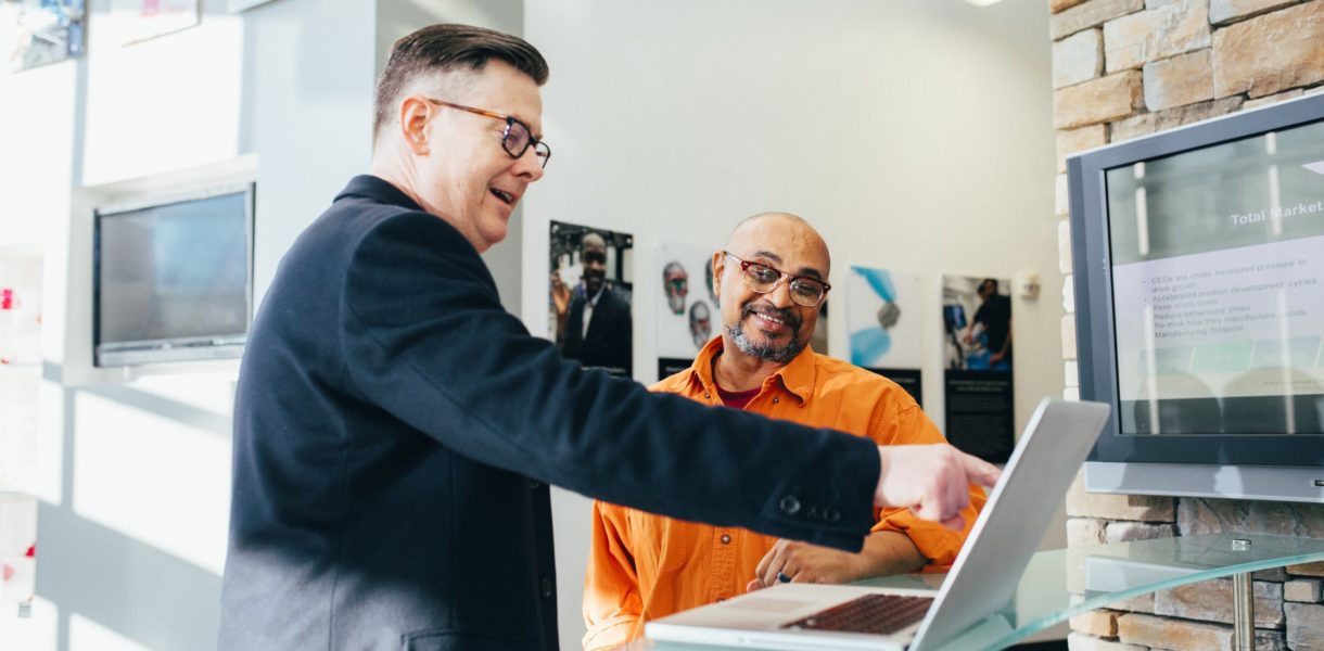 man pointing at laptop