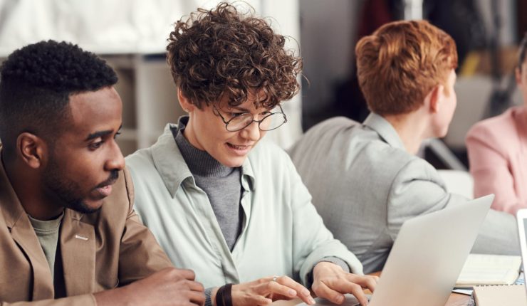 group of people working at desk in office